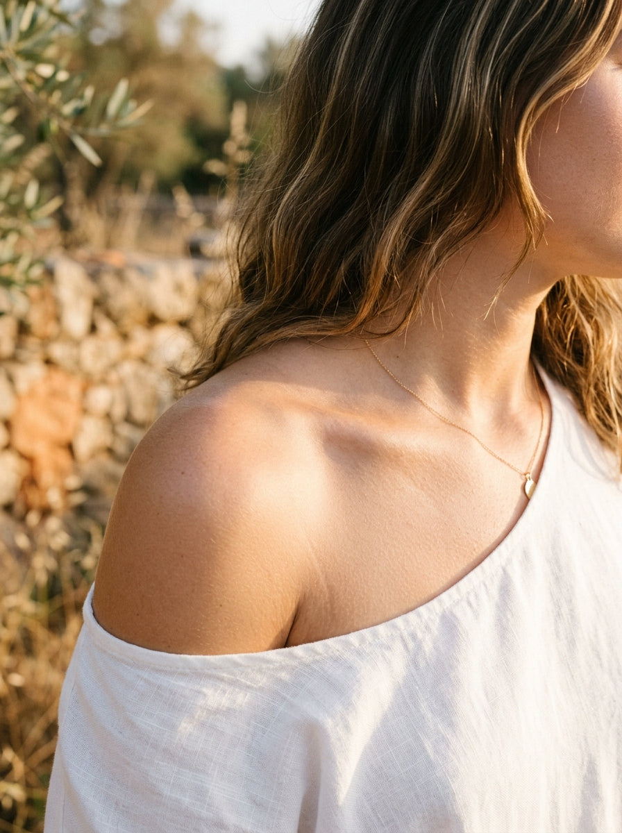 soft glowing feminine skin collarbone warm golden light editorial beauty
