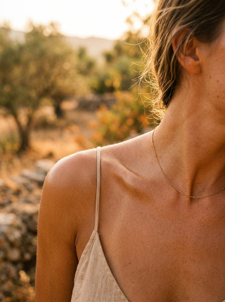golden bronzed feminine shoulder collarbone warm sun halo Mediterranean summer editorial