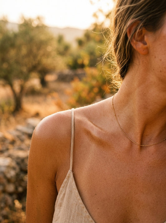 golden bronzed feminine shoulder collarbone warm sun halo Mediterranean summer editorial